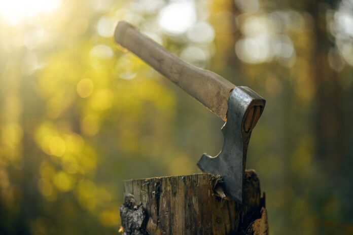 A,Metal,Axe,With,A,Wooden,Handle,,Stuck,In,A